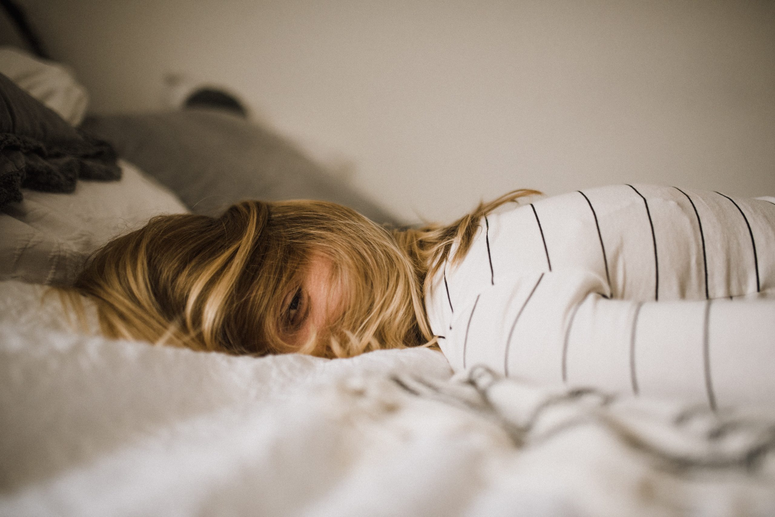 Girl lying on bed, face down, hiding - Depression in Teenagers