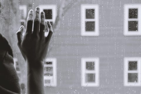 Woman's hand on window - Seasonal Depression