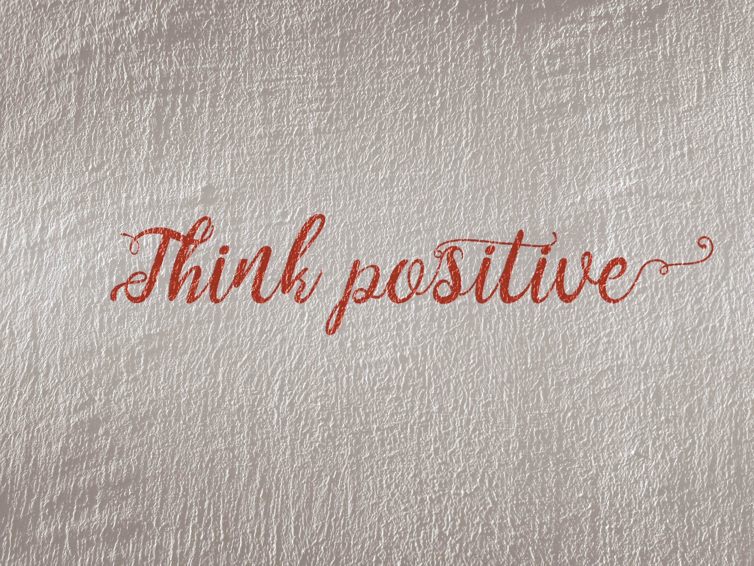 Think positive written in red on a white background 