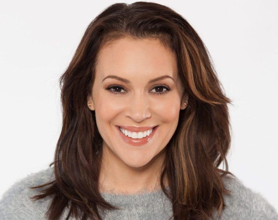 Alyssa Milano in grey sweatshirt, smiling