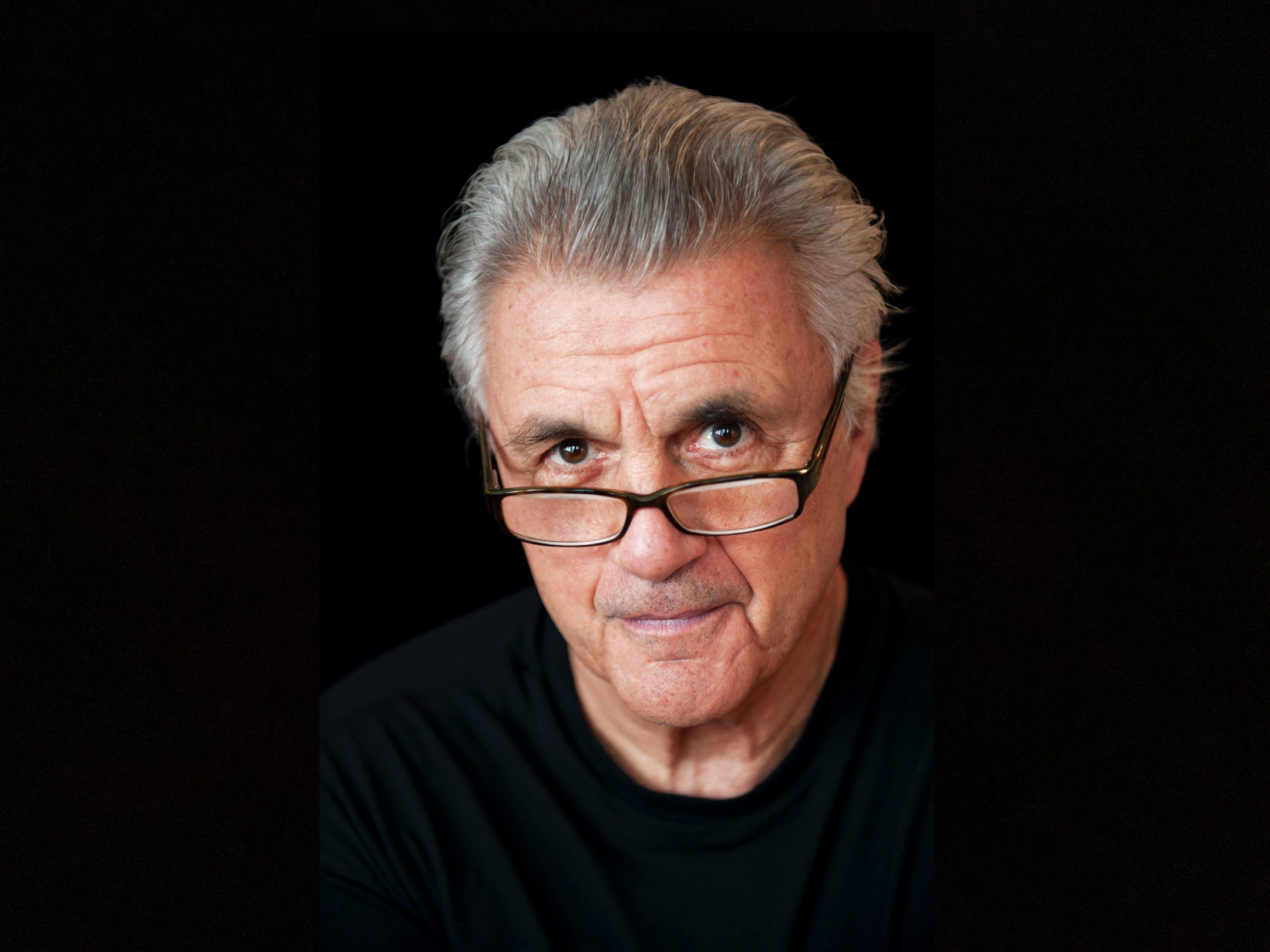 John Irving in black framed glasses