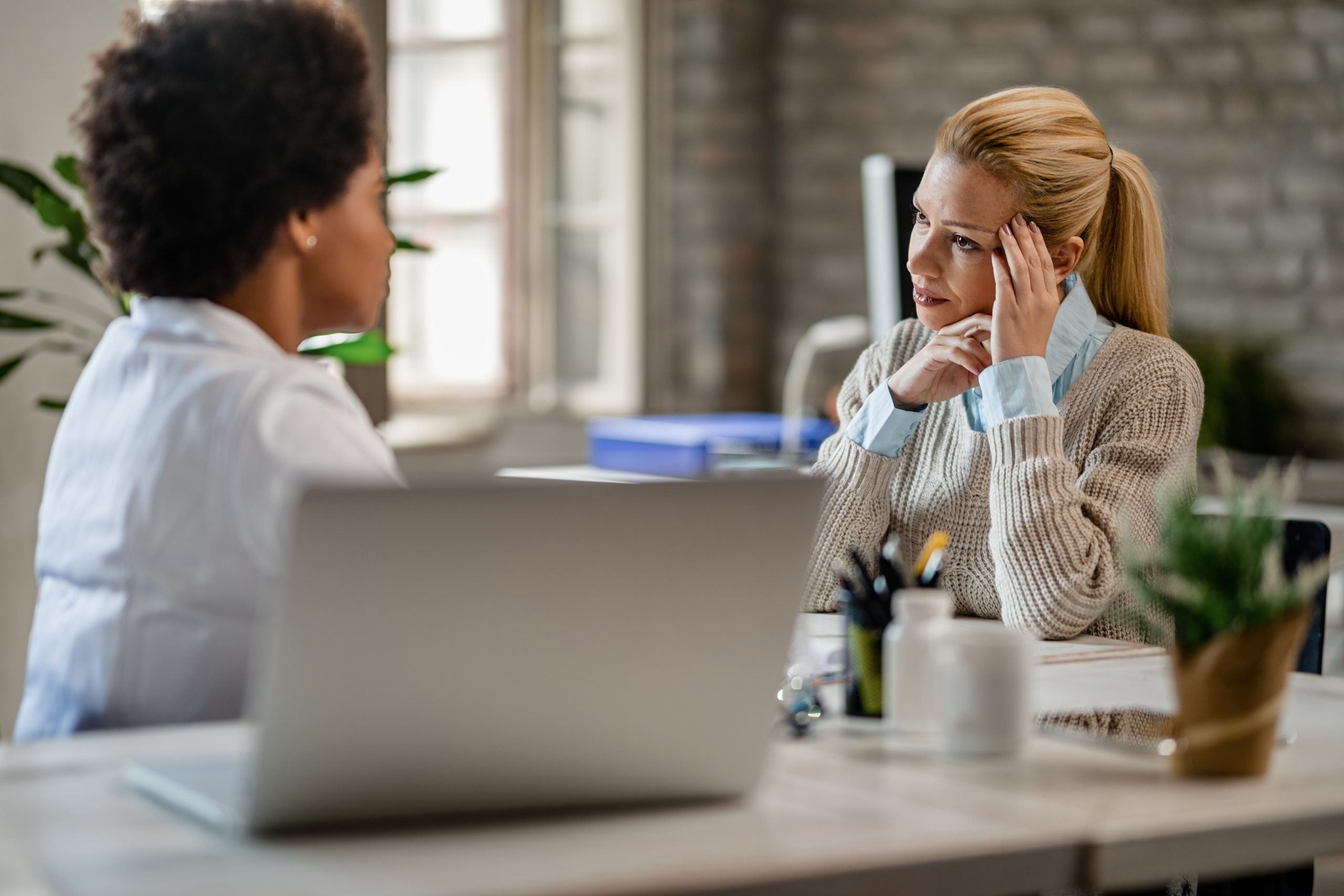 Two women talking in a workplace