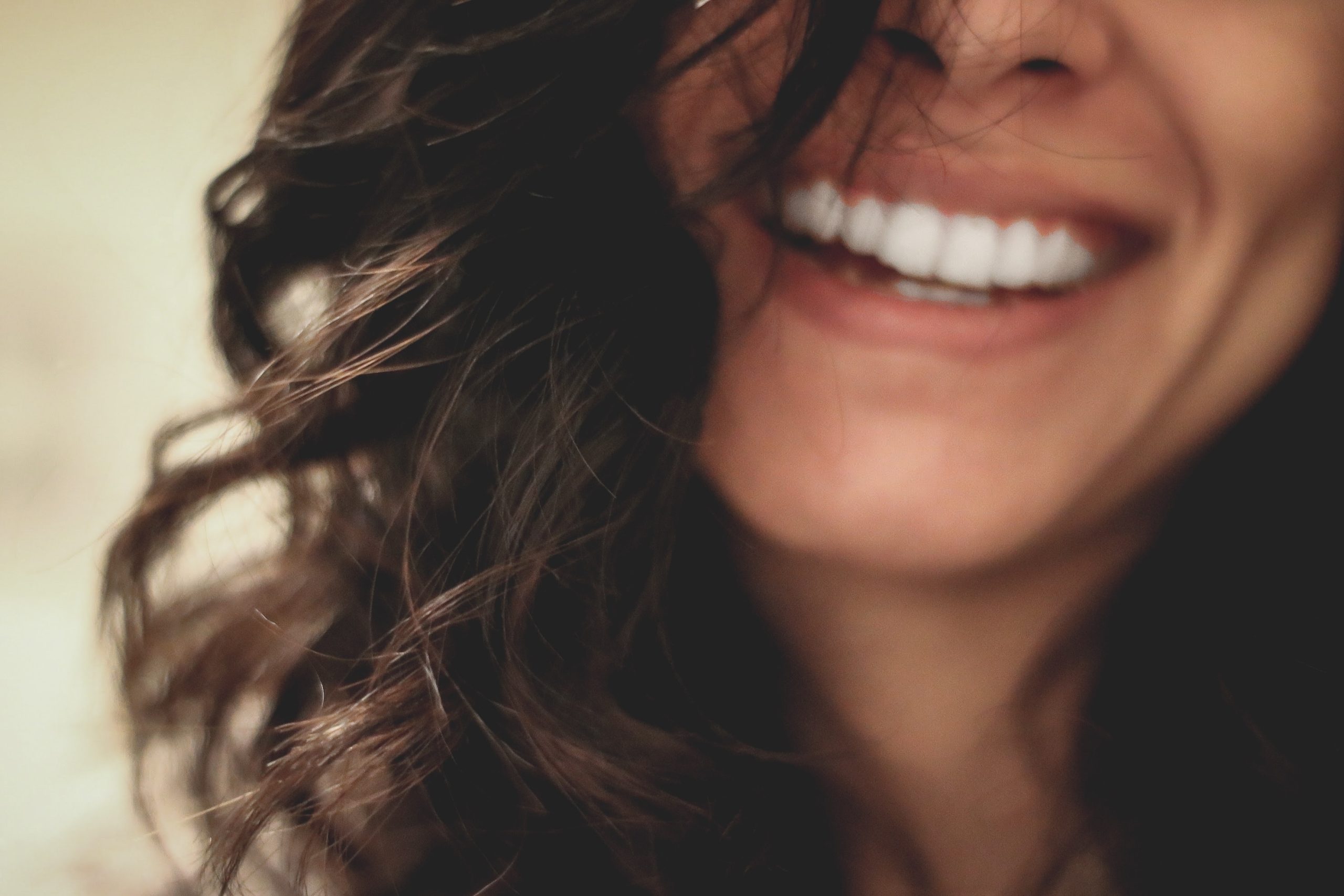 Half face image of woman smiling. Hope and Belief. Science of happiness.