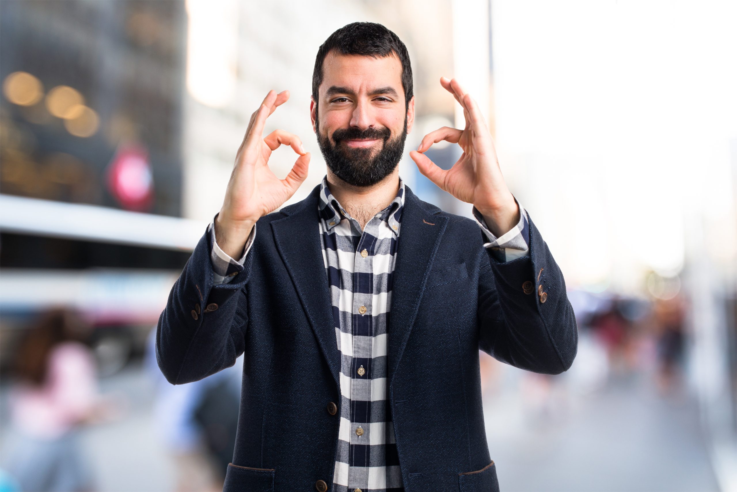 man making ok sign to show positive affirmations